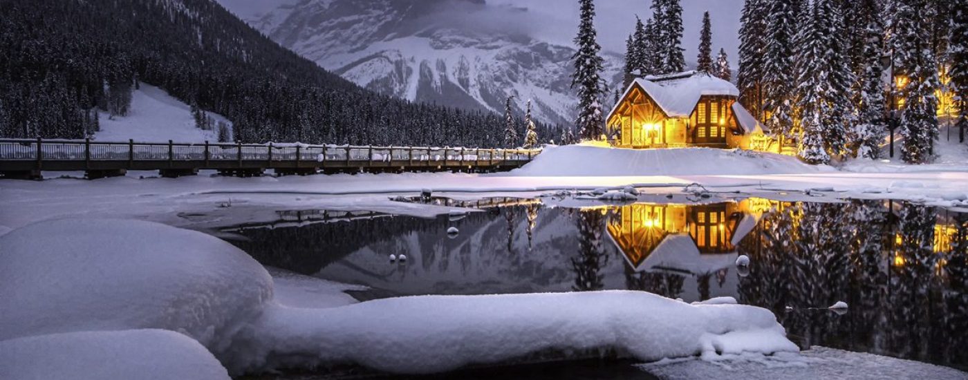 A cozy wooden house by Emeral Lake in the winter.